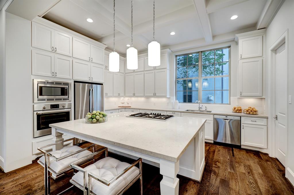 The large island in the kitchen serves as a breakfast bar and serving area.