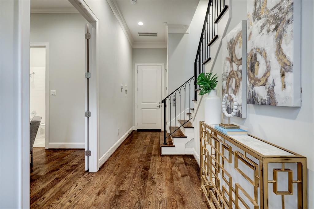 Entry hall with study at left and elevator and door to the garage at the far end.