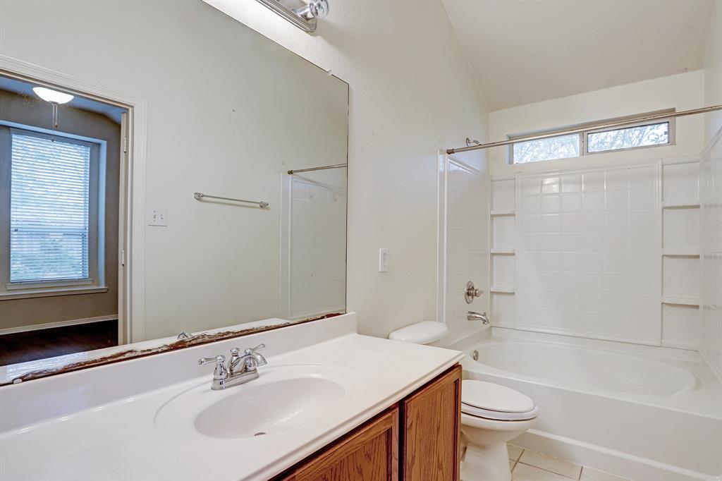 The primary bath includes a wide vanity, combo shower/garden tub and a walk-in closet (out of the photo to the left of the vanity).