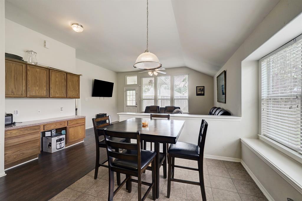 Between the kitchen and family/living room is a breakfast area for casual dining.  The windows overlook the side yard.  Conveniently this space also includes a desk area with cabinet and drawer space (to the left).