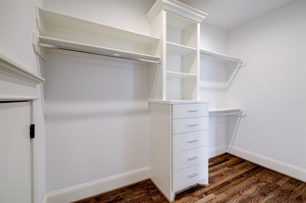 Huge walk-in closet located off of the primary bath. Custom cabinets for best use of space.