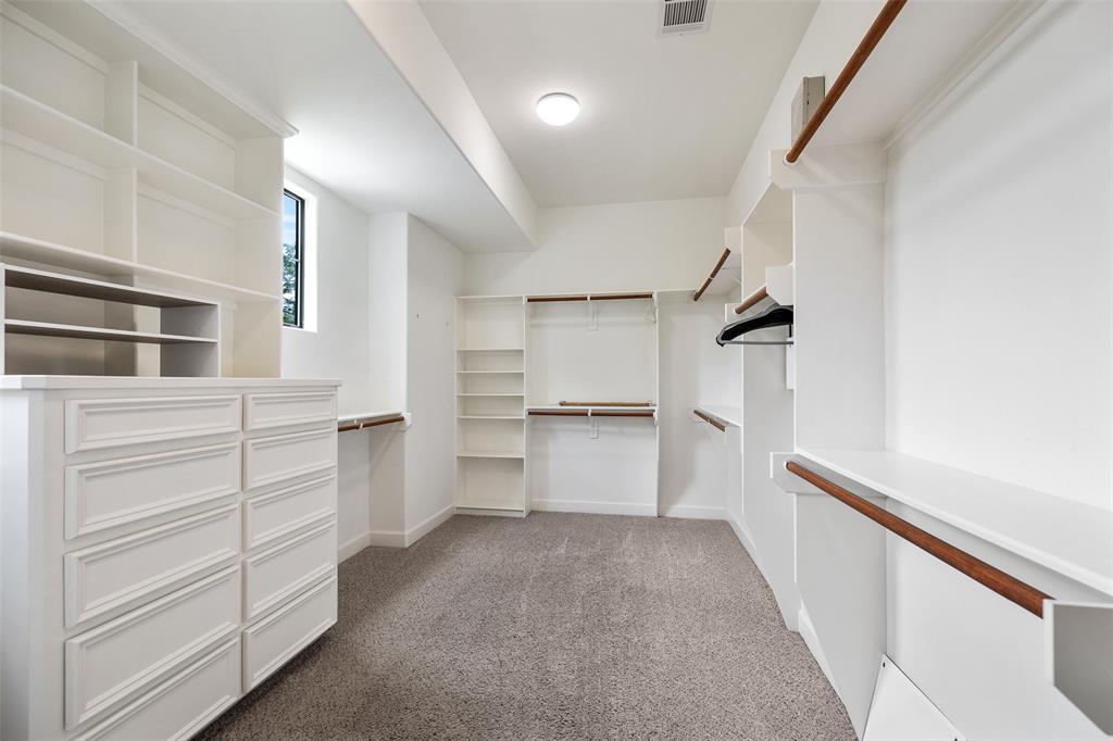 Wow! Check out this large walk-in closet located just off the primary bathroom.