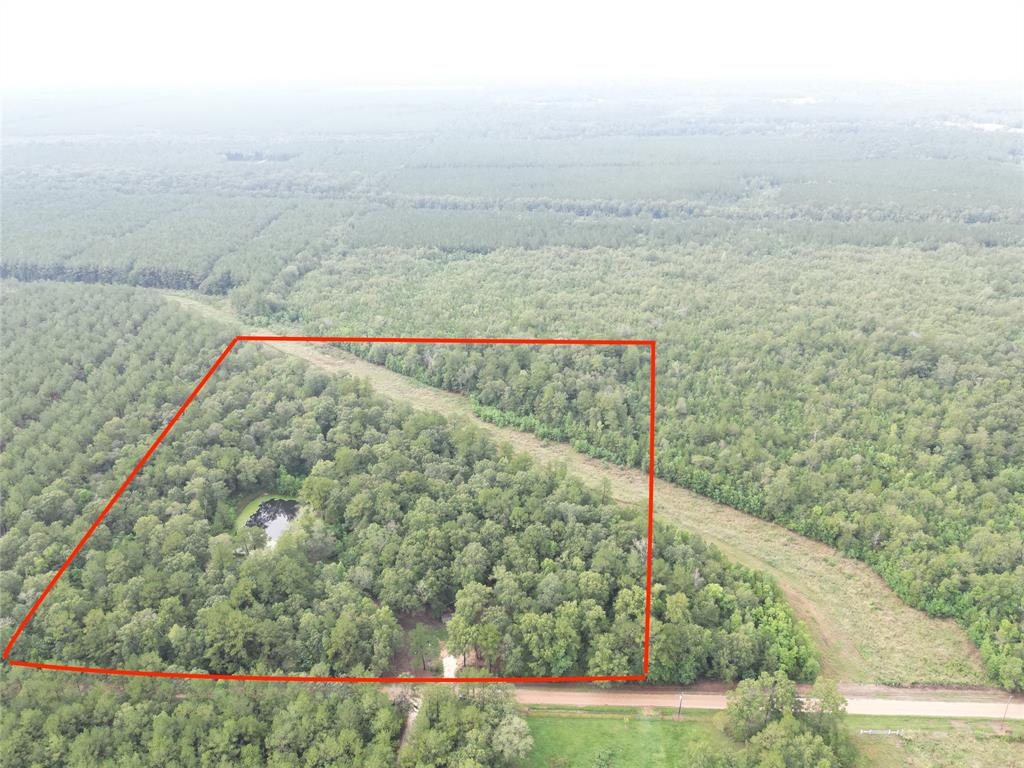 Don't miss your chance to own 15.77 beautiful acres! This property is mostly wooded with a couple of areas that are cleared. The property offers a large pond that is roughly 35 feet deep and is fully stocked with Bass, Bluegill, Catfish, ETC... This property is just .2 miles off from SH-146 and is surrounded by large tracts of land. Once you arrive at the property, it's incredibly peaceful. This is true country living.