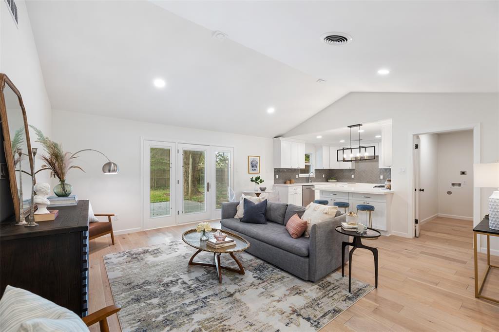 The open floor plan features a vaulted ceiling in the living room and lots of natural light.