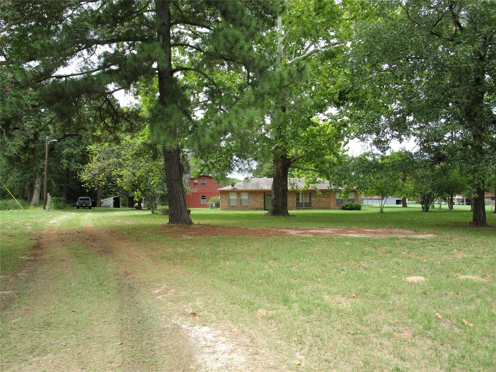 QUITE COUNTRY LIVING ON THIS 9 ACRE PROPERTY LOCATED ON ACR 1221 IN GRAPELAND, YET IN MUST SOUGHT AFTER SLOCUM SCOOL DISTRICT. OLDER THREE BEDROOM TWO BATH HOME IN VERY SOLID CONDITION JUST NEEDS A FEW COSMETIC UPDATES. LARGE DEN, OPEN TO KITCHEN COMPLIMENTED WITH BREAKFAST/DINIG AREA. LARGE SUN ROOM WITH WASHER DRYER CONNECTIONS OVERLOOKING BEAUTIFUL COASTAL PASTURE OUT BACK. TWO CAR DETACHED GARAGE WITH SECOND FLOOR UPSTAIRS FLOORED, ELECTRICITY AND AC WINDOW UNIT FOR POTENTIAL LIVING QUARTERS, OFFICE OR STORAGE. IN ADDITION AN OLDER BARN FOR EQUIPMENT AND STORAGE. 75X50 HIGH FENCED AREA FOR GARDEN, DOG RUN, OR ENTERTAINING IN BACK YARD. LARGE TREES SHADE THE FRONT AND BACK YARDS, WITH 4-5 ACRES OF WOODS TO MAKE THIS A VERY PRIVATE SETTING.