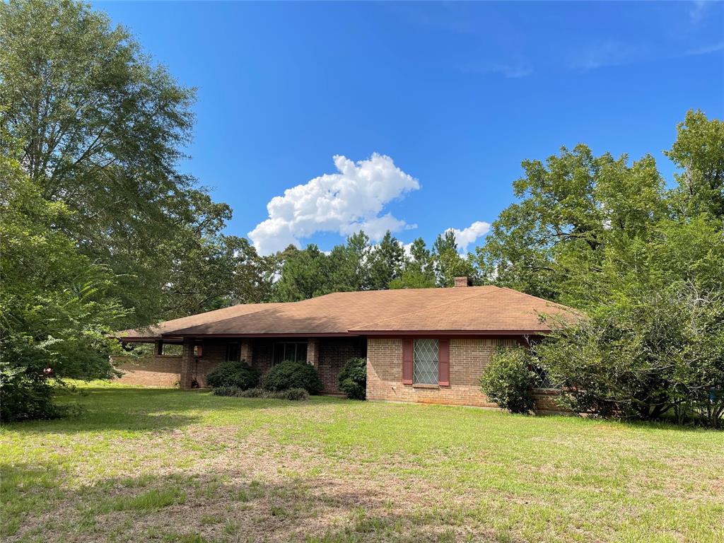 This well kept brick home is on five very secluded, beautiful acres. Perfect for starting a small homestead or raising a family in the country! The home is shaded by huge old oaks and surrounded by woods and a meadow. Inside, the wood floors are gorgeous and there are new granite countertops in the kitchen. The rest is blank slate, ready for your updates or enjoy it's vintage charm. If you'd like to live in the country but still be able to commute to Lufkin or Nacogdoches, look at this one!