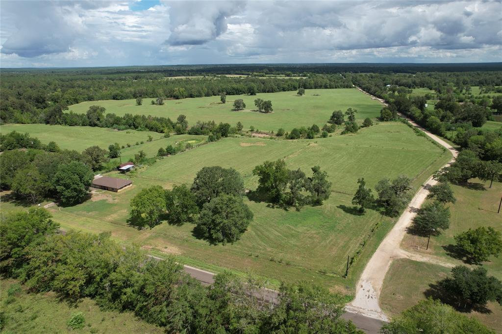 This 94.20-acre property has land on both sides of FM 1280 East with approximately 1500’ feet of frontage, and approximately 2500’ of frontage on Rosser Lane. The road frontage on this property makes it perfect for subdividing. This property offers beautiful pastureland, 3 ponds,2 tributaries of the Little White Rock Creek, and approximately 14-acres of this property is heavily wooded with mixed hardwoods and pine. This property is a great setup for livestock and hunting. On the property you will find a two bedroom, one and one-half bath brick home that has been well maintained through the years. This home has large windows in the living area with gas fireplace and nice kitchens. One bedroom is fit with a ½ bath and shares a full bath. There is an attached 2-car garage, as well as a 2-car carport. There are also 4 storage barns, one is located behind the home and three more are further down the property. Give us a call today to see what this property has to offer you!