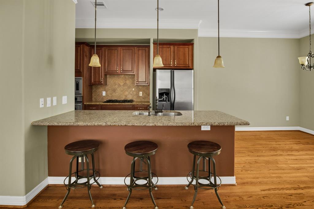 The breakfast bar between the kitchen and living room makes for a great place to entertain, or just sit down and enjoy brunch.