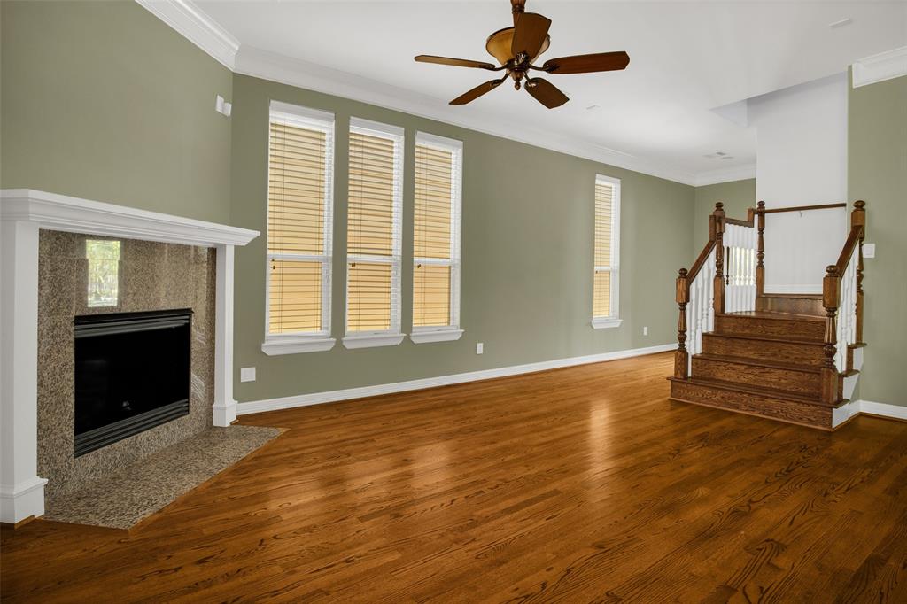 View of the living room and fire place.  Note that these hardwood floors are in pristine condition.