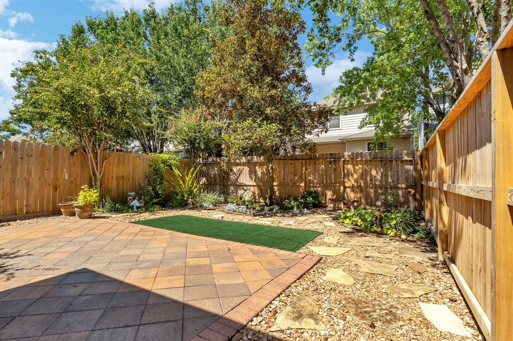 The back yard is just off the dining room porch area. The flagstone patio area is a great place for an outdoor table or grill.