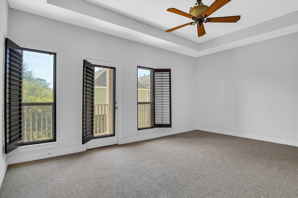 The balcony door and windows feature wood plantation shutters in the Primary Suite.