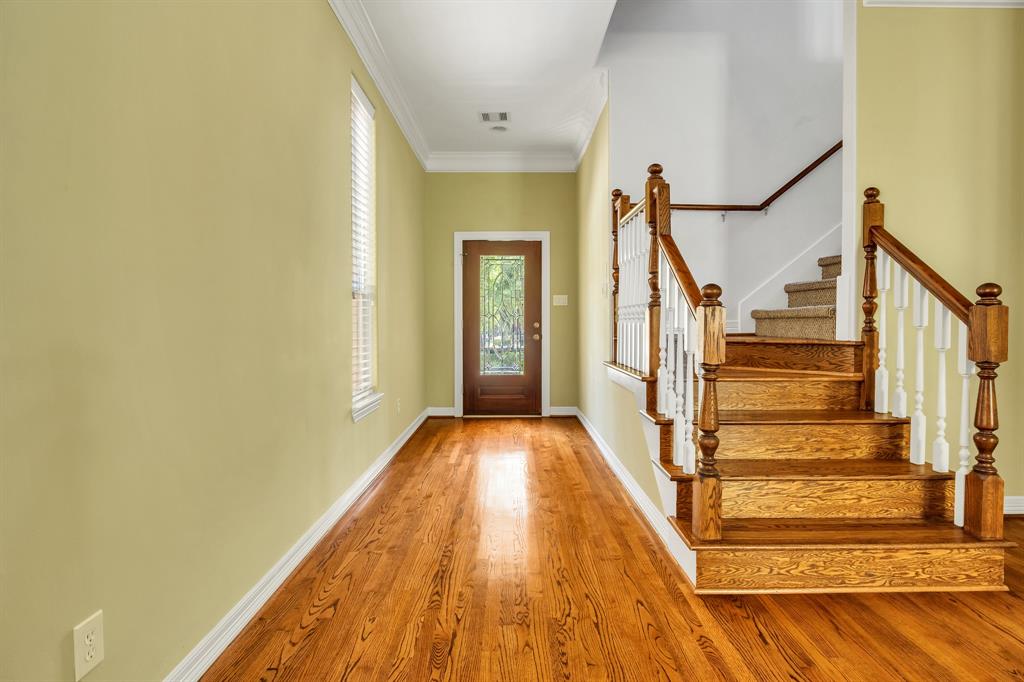 View of the long entryway from the front door. These hardwood floors are gorgeous!