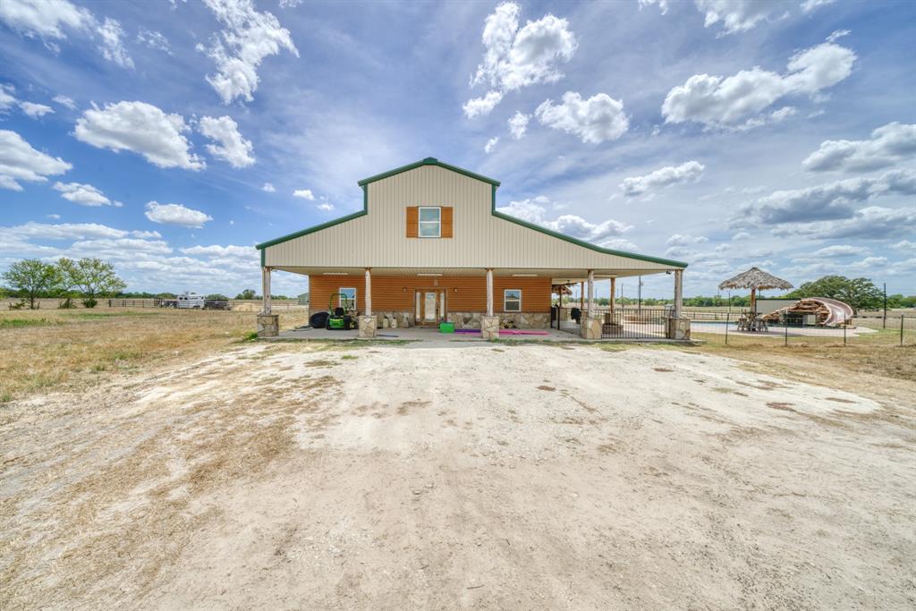 Custom built BARNDOMINIUM with 30 acres and a HORSE LOVERS HAVEN.  Home has 4 bedrooms, 3 full baths,
with an additional "2" 1/2 baths.  Home has many upgrades including beautifully finished woodwork, copper sinks, walk-in pantry, Bucher Block counter tops with excess to large utility room.  Open concept Kitchen/Family & Dining
Room.  Main Bedroom is on the entrance level with a large bath & VERY large/gorgeous walk-in show.  Upstairs comes with a large Gameroom (1/2 bath), 3 bedrooms (2 full baths). Gameroom has double doors, balcony with
outside entrance overlooking heated saltwater pool with waterfall, safety fencing, outdoor Kitchen. Horse facility
attaches to back of home with 5 stalls, indoor wash rack, tack & feed storage room. Out from the home & barn is a 200x325 roping arena, with lights, roping boxes, automatic remote controlled roping chute, working pens.  Separate shop on property that is 1/2 shop & 1/2 living quarters with 3/2 bed/bath & Kitchen.  All has aerobic/well