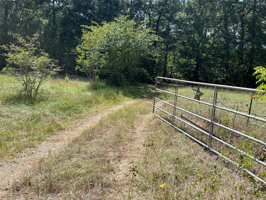 2.3 acres of Unrestricted Property in Montgomery County.  No HOA.  Montgomery ISD. The property is fenced and gated.  It has 2 pads for mobile homes.  There are feed stalls and a detached garage.  Septic and well. The seller is an executor of the estate.  This property has great potential for a home in the country!