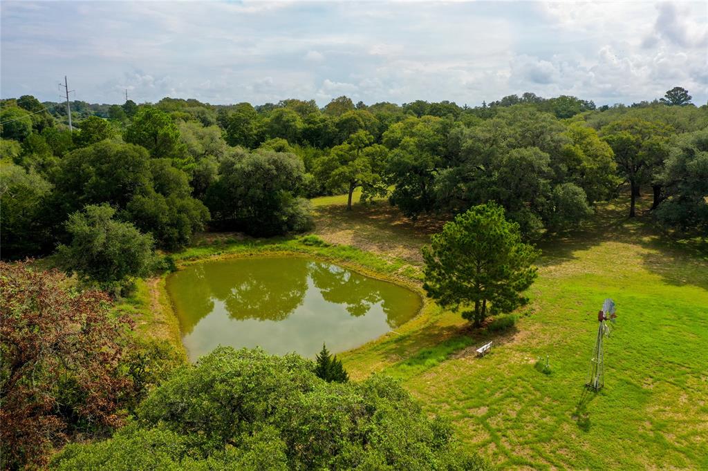 Location! Location! Location! Beautiful quiet property convenient to I-10, schools, & shopping.  Many mature live oaks trees. 50% open, 50% wooded.   Pond with solar windmill available. Ag exemption in place to help keep your taxes low!  Drive out to the country to see this one soon.