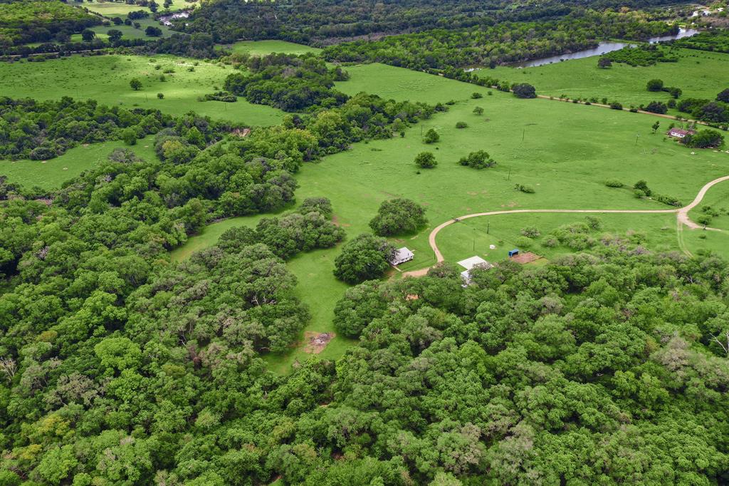 RARE Park like, 9 Ac Ranchette, on hill w/ 100+/- Live Oak, seasonal creek, great views! 30x40 steel framed metal Bld, w/ concrete floors, hog fenced property, horse stall and pens. Tranquility, Only 2.4 miles off I-10. Modular home Ideal for a weekend get away or country living. Well and septic.