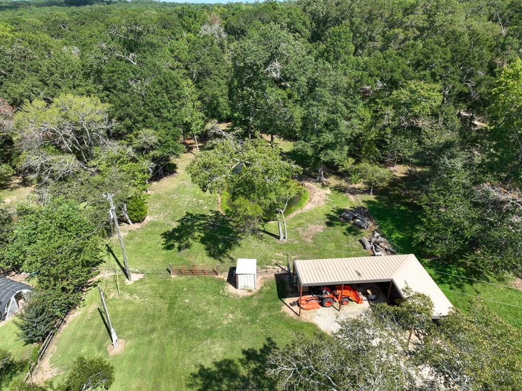 Secluded acreage but in the heart of progress! Located in the desirable FM 1097 area, but away from nearby developments. Property has a gentle roll and slope to the Northern property line, bordered by “Hegar Branch.” Hegar Branch is a spring fed creek – beautiful, clear, and cold waters year round. A mix of hardwoods cover the property with certain areas having been under-brushed by hand, providing for a clean understory. Walking/riding trails throughout with culverts already in place in natural drainage areas. RV cover and three sided barn placed at the front of the property with aerobic system, water well, and electricity already in place. Small pond attracts wildlife. Easy access to Willis and New Waverly. For secluded, country living – look no further!