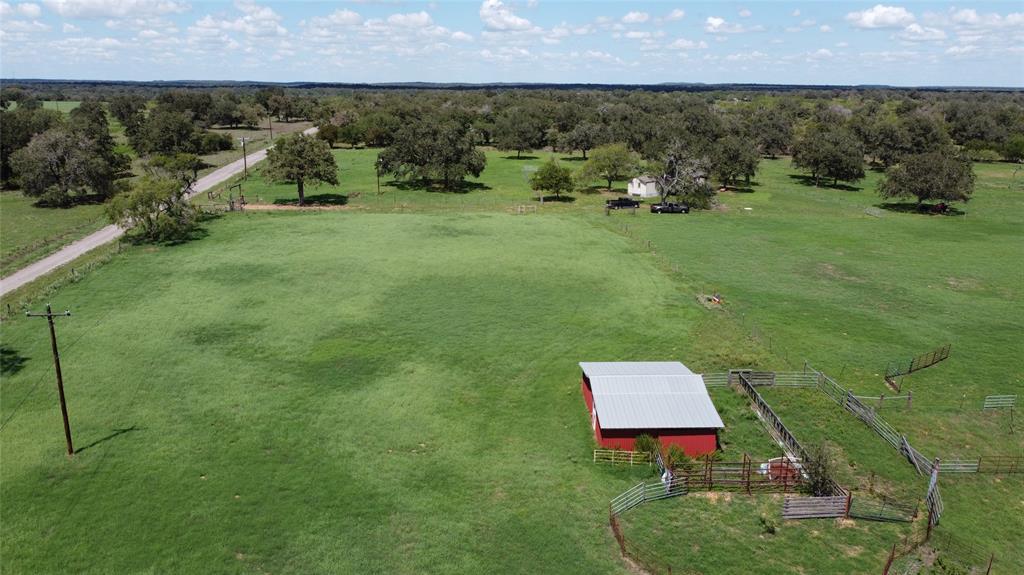 Ready made Cow/Calf operation with huntable 91.4 +/- acres.  Great access just south of I-10. SE of Seguin.  20 acre coastal  bermuda hay field.  Small barn with storage and working pen.  Fenced and Cross fenced for cattle.  Improved pastures frontage acreage.   Acreage  behind hay field has scattered Oak canopy and some native trees. Selectively cleared with grazable acreage for cattle and set up for hunting with feeders and blinds.   Acreage is driveable with 2 ponds. Season creek crosses southeast corner. 2001 manufactured home move-in ready with new a/c and well.