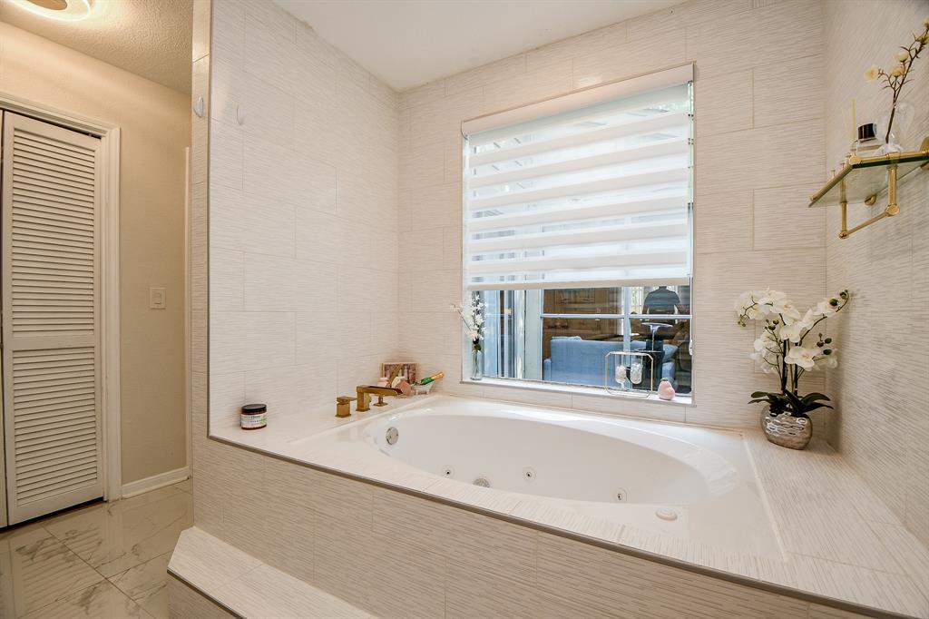 Float your cares away in this luxurious jetted Hollywood bathtub with new tile surround, as part of lush updates.