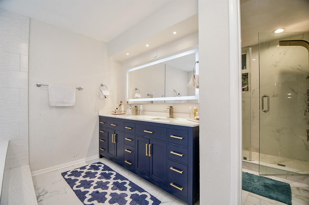 Updates to the primary ensuite bath also include the state-of-the-art glass enclosed shower and bright double vanity.
