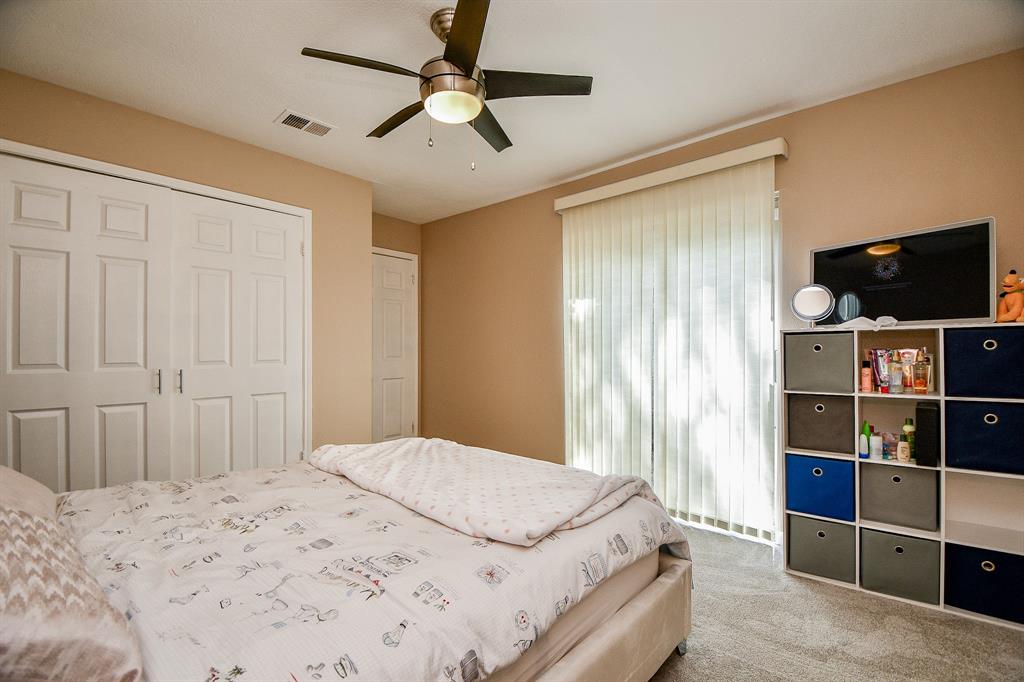 Another spacious secondary bedroom is bathed in natural light.