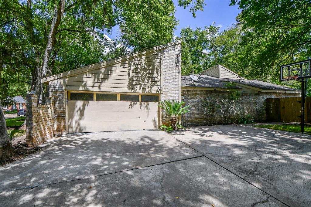 The attached garage sits atop a generous driveway.