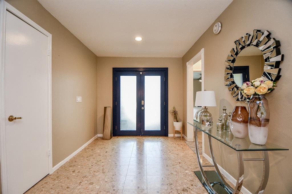 Tranquil earth tones grace the walls and beautiful tile floor at the entrance (from the inside) to the home.