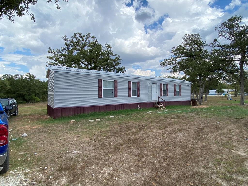 Don't miss this secluded and private 1 acre property. The energy efficient 2020 manufactured home has 2 bedrooms with 2 bathrooms. The living area and kitchen are open with tall windows looking out into the backyard. The main living areas has laminate flooring and the bedrooms have carpet. The primary room has a large walk in shower with a large tub and 2 sinks. This property is at the end of a road that makes it private and peaceful. There are large oak trees and plenty of wildlife.