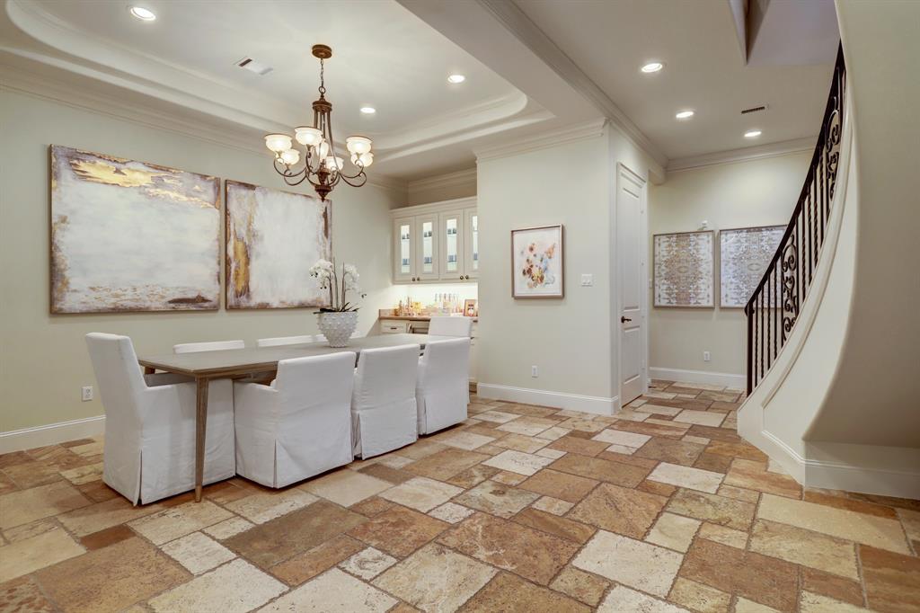 Generous size Dining Room with Chiseled Travertine Floors, Coffered Ceiling and Dry-Bar.