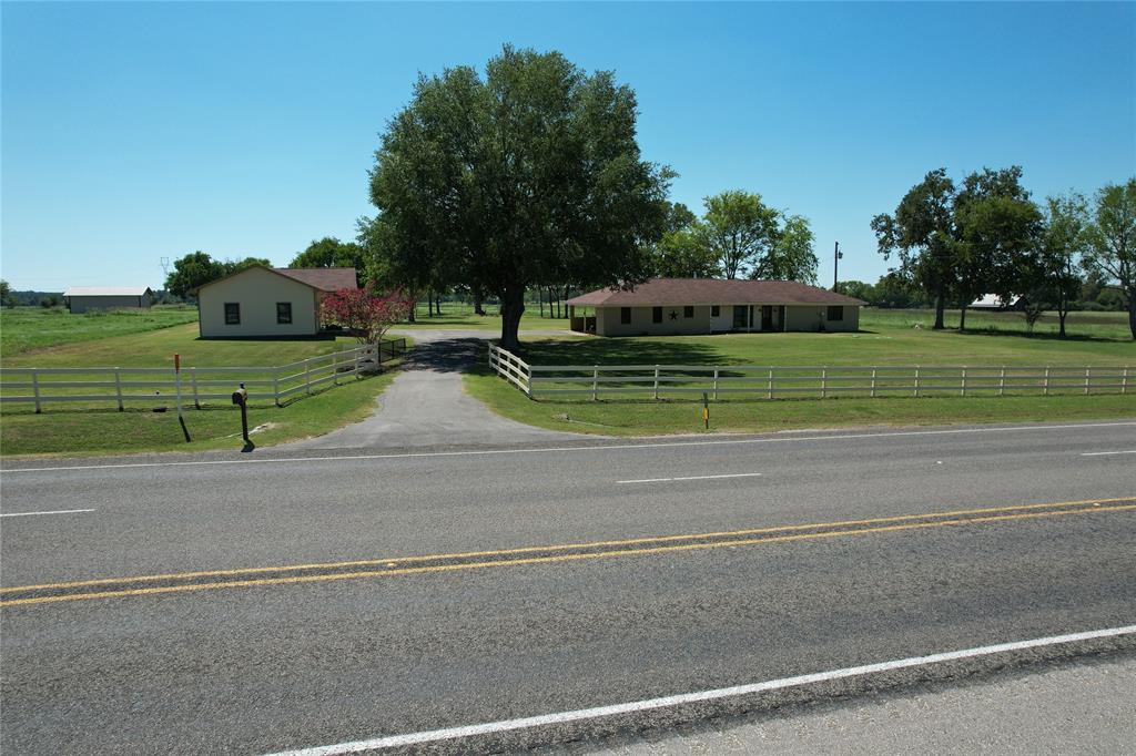 This three bedroom, two bath brick home sits on 10.821-acres, just minutes from Loop 304 in Crockett, TX! The home is like brand new with recently installed floor coverings, windows, doors, cabinets, appliances, fresh paint, and more. You’ll enjoy the large open living area with wood burning stove, kitchen with breakfast area, and sunroom across the back of the home – perfect spot for that morning coffee. There’s plenty of room for guests with three spacious bedrooms, two bathrooms, and a handy laundry. Outdoors, you will find the attached two-car carport, as well as a 24x48x10 barndo with shop/office and great storage. The barndo is the perfect man-cave or could easily be converted into guest quarters.  There is also a 24x24x10 hay barn and a stocked pond loaded with catfish. This property is fenced and has pretty pasture, great for hay production, livestock, and gardening. Call today!