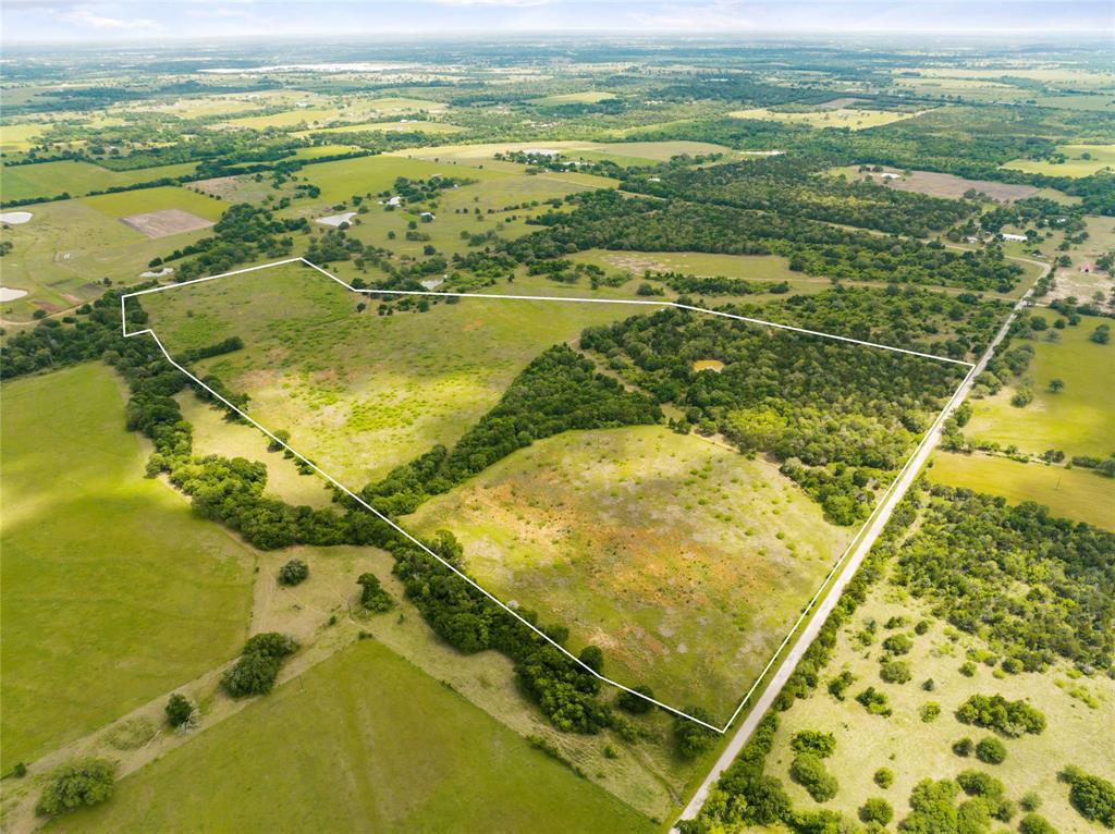Unique opportunity located just outside of Austin, this beautiful +/-64 acre property offers impressive views, nearly 1300' of paved road frontage, and great access to US-290 & Hwy-21. Situated in western Lee County, the Elm Creek Ranch sits 3 miles east of Paige between Bastrop & Giddings. In addition, the property is conveniently located just one mile from major highway(s) US-290 and Highway-21 which offers easy access & various travel routes into North Austin, South Austin and Downtown. With over +/-1300 feet of paved road frontage and water lines along the roads, The Elm Creek Ranch would make for a perfect multi-use property. There is power on-site and along the county road. The land offers rolling topography with over 40 ft. of elevation change and has a nice sized stock tank surrounded by hardwoods. The tract consists of a combination of densely wooded areas, scattered trees and plush pastures. The property is Ag Exempt and is currently being used for grazing.