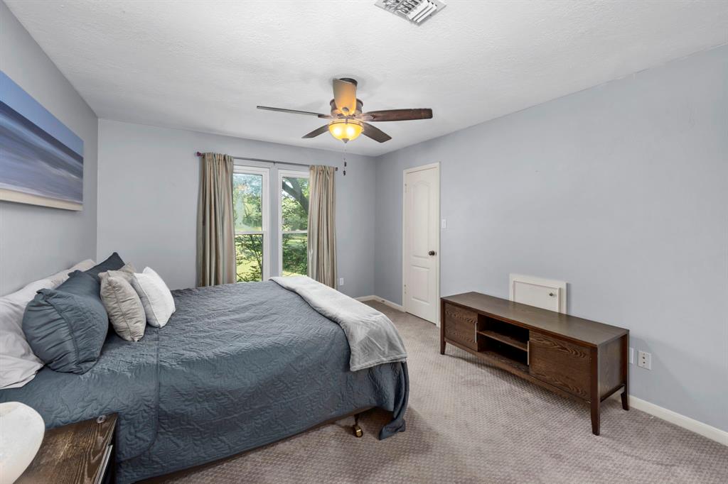 The second bedroom upstairs is bright and spacious with clean carpet, ample closet space, and a ceiling fan. The Jack & Jill bathroom is thoughtfully attached.