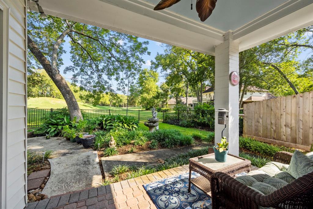 The covered patio overlooks the lush backyard and golf course, beautifully shaded by towering trees that you simply can't find in newer neighborhoods.