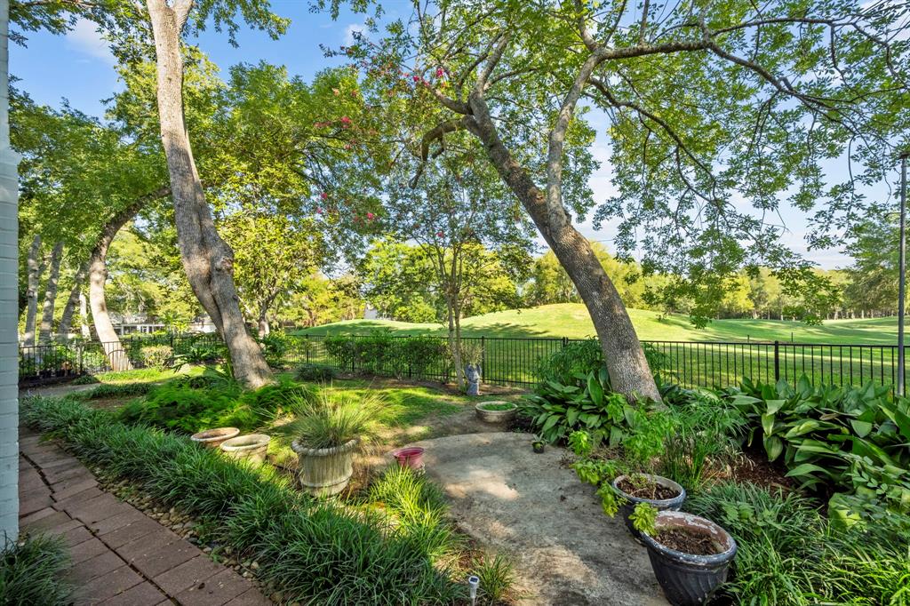 This serene backyard with lush landscape overlooking the golf course could become your daily view!