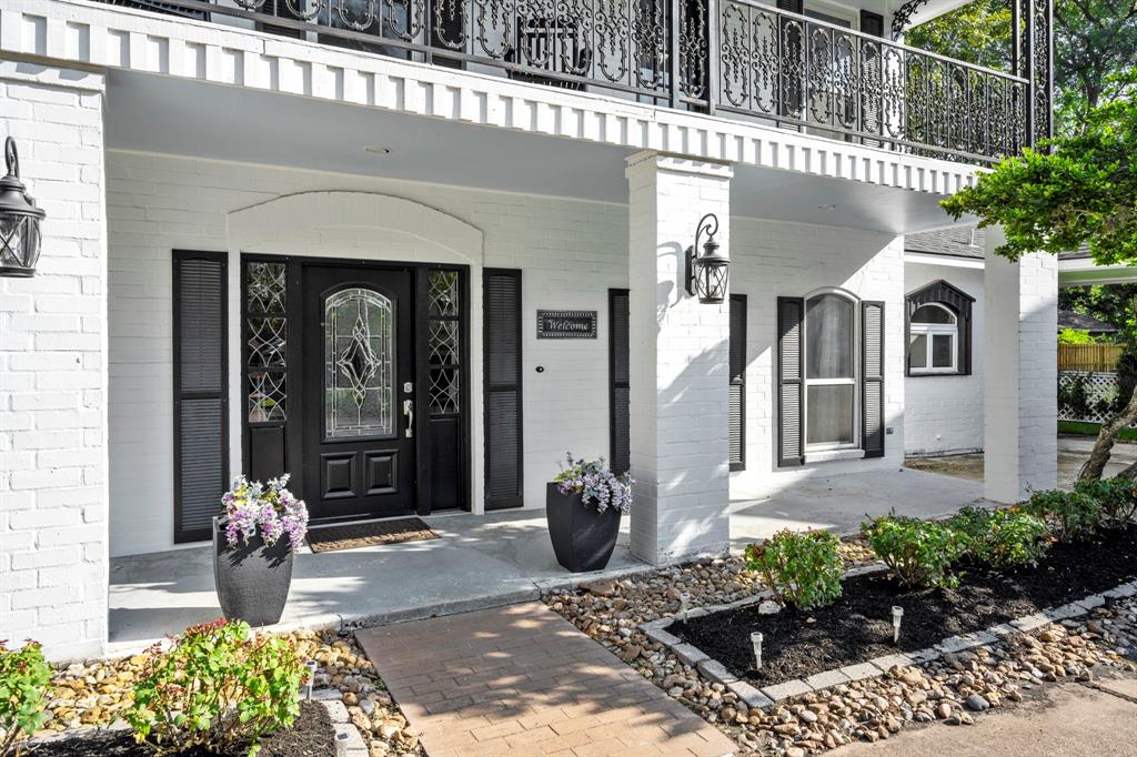 A charming brick covered front porch with stately pillars, sconce lighting, and a decorative beveled glass front door welcome you and your guests. Take a look inside - you will not be disappointed!