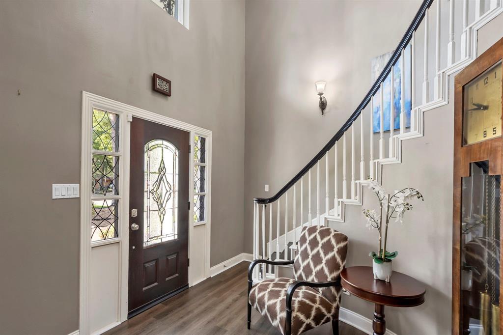 Step inside the foyer to be greeted by soaring 2-story ceilings and luxury vinyl plank flooring. A stately rounded staircase invites you upstairs to a game room, sun room, and 3 guest bedrooms.