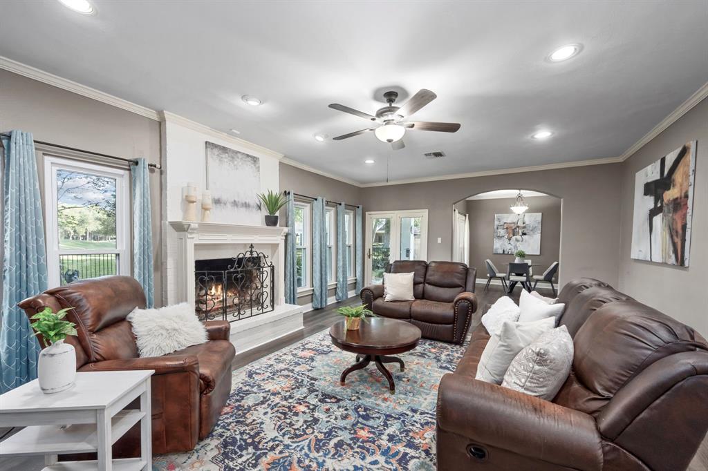 This spacious family room is the heart of the home, where many windows with custom treatments offer unbeatable views of the backyard and golf course.
