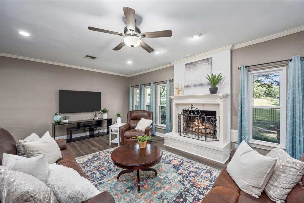 Additional features of the family room include an upgraded ceiling fan, plus a cozy gas and wood-burning fireplace to create the ultimate focal point.