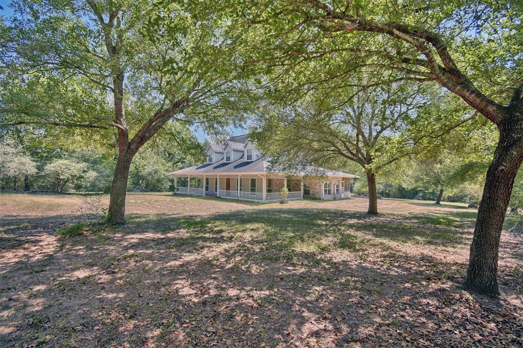 Beautiful home on 5 acres about one mile from Bellville town square.  Three bedrooms, 2.5 bath.  Primary bedroom and bath are on first level, other two bedrooms and full bath are up-stairs, half bath is on first level.  Screened in back porch spans the full width of home for leisurely mornings or evenings with family and friends. For those with serious hobbies, the metal built, concrete floored, garage/shop provides ample space for up to four automobiles.  If privacy is one of your priorities the home is hidden behind a lush yaupon thicket and oak trees.  Open space in back of property to garden, corral pets or admire the wildlife that will meander through. Call for an appointment today!!!