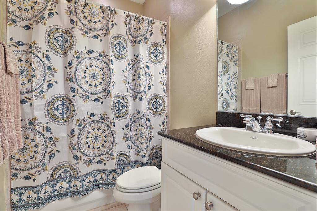 Secondary bathroom features a tub/shower combo.