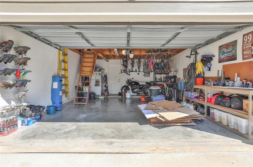 The two car garage has been updated with a very useful large extra storage space complete with stair entry.
