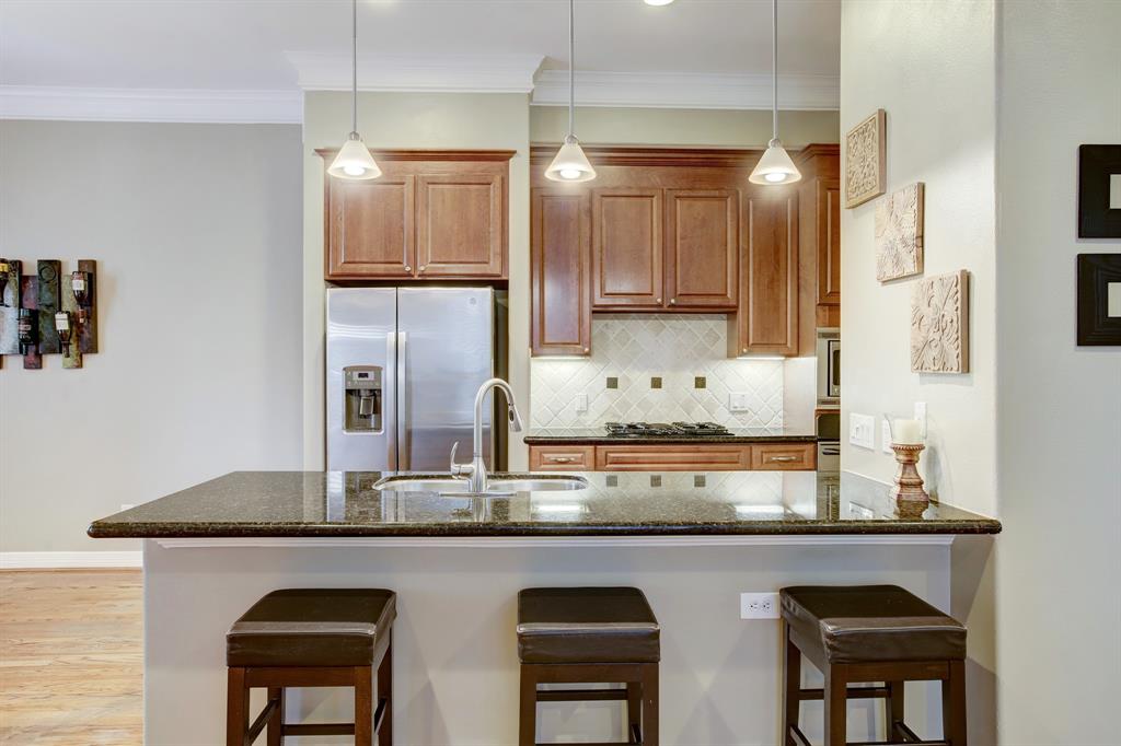 Entertain friends and family, or just enjoy brunch at the breakfast bar. The refrigerator in this photo is included in sale of the home.
