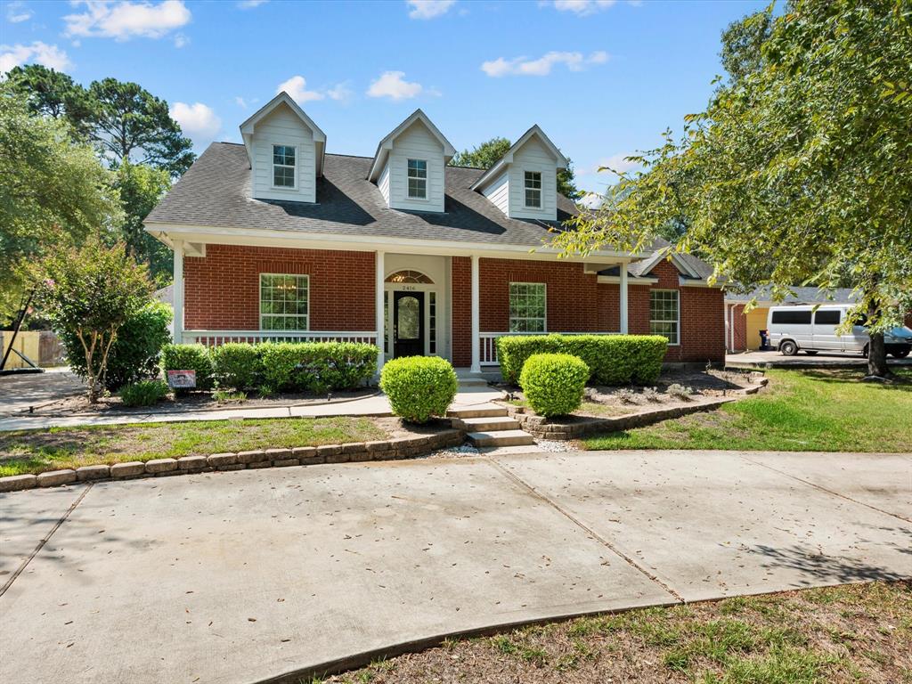 2416 Coachlight Lane Conroe, Texas Beautiful upgraded one story in desirable Carriage Hills. Excellent Woodlands Schools. 4 bedrooms 2 1/2 bath. Kitchen has all stainless steel appliances and open to breakfast room and living room. Beautiful light fixtures throughout this home plus tons of natural light in every room. 2 car detached garage with extended workshop or man cave. This home offers a huge backyard with a covered patio and includes a large hot tub and privacy fence! Large front porch and spacious circle driveway with ample parking. Neighborhood offers basketball courts, a playground, a pool and even a pond for fishing! This home is a must see!