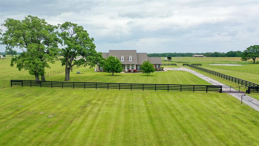 Your country estate in Madison County awaits! This beautiful custom home on 27.96 acres was well thought out and has all the bells and whistles one would want in their forever home. This 3 bedroom 2.5 bath brick home consists of  3,000 sq ft of living space. If you like big rooms you will love the large kitchen, living room, primary bedroom with an extra room attached, and primary bath with awesome his and her walk-in closets!  There is plenty of room to host gatherings inside the sunroom or out on the patio/outdoor kitchen whatever the weather permits. Behind the house, there is a 2,200 sq ft shop, a 20x60 shed, 2 loafing sheds, a 2,000 sq ft hay barn, and a covered RV shed. The property is fenced and cross-fenced and has cattle sorting pens next to the barn. This property has it all! Call The Wells Team to schedule your showing today!
