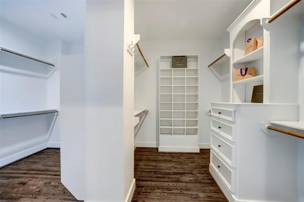 The master closet has two sides with built in shelves and drawers
