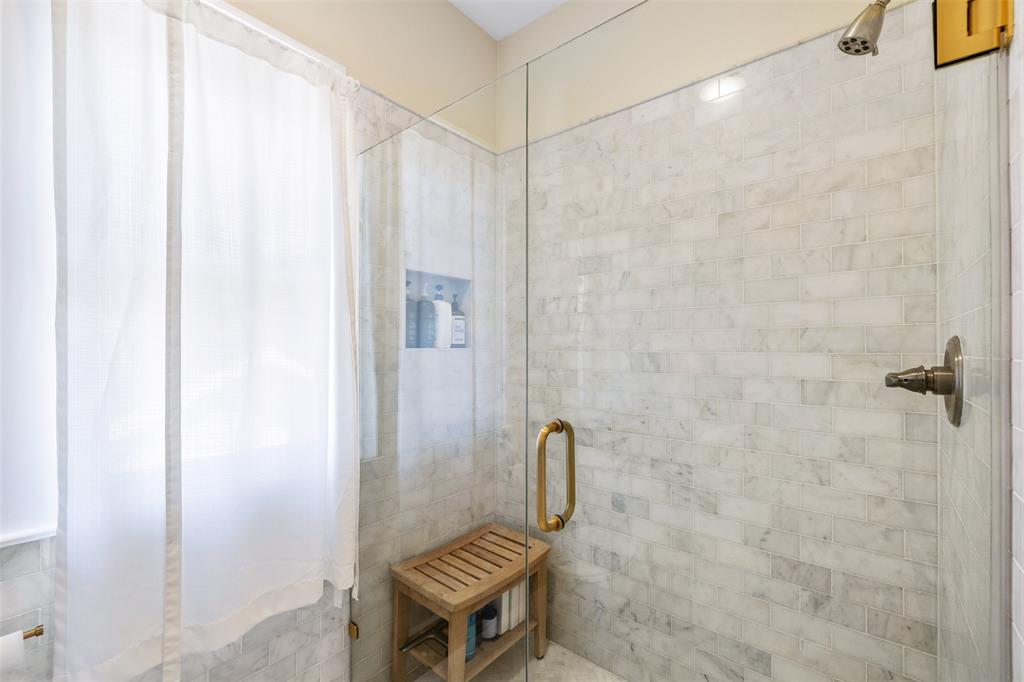 The primary bath shower with modern glass door.