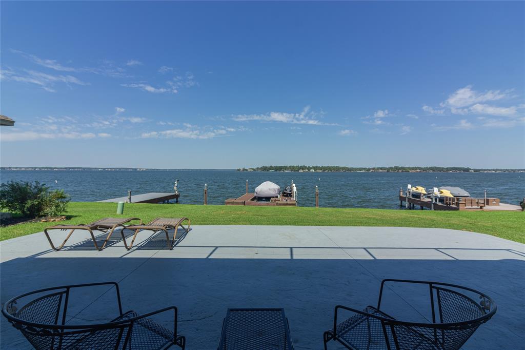 FEEL LIKE YOU ARE ON VACATION EVERY DAY in this spectacular property with WIDE OPEN WATER VIEWS of Lake Conroe! Enjoy the endless water views from the large covered patio, or 2nd story deck, or from the COMPLETELY REMODELED home with abundant views of the lake. This home was TOTALLY REMODELED with quality and designer touches through out. You'll enjoy the NEW roof, AC, water heater, flooring, kitchen, bathrooms, windows, doors, and more (ask us for a full list). You'll love the floor plan - nice and open, and has great windows for natural light and BEAUTIFUL LAKE VIEWS! A light, bright and cheery feeling combined with the many luxurious touches in this home create an ideal environment to relax and live a vacation-style life everyday! Not only is this home amazing itself, it's also close to Conroe, The Woodlands, Montgomery, and even IAH and Houston if you need to commute. Most furnishings can be included in list price offer. Lake toys available separately. Come get this beautiful home!