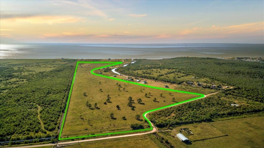 The most phenomenal water view around of Trinity Bay! Across the way, a private canal that flows out to open water!! Undeniably the most hidden gem and location in Anahuac!! Just over 57 acres in a secluded community. Approximately 1,118.94 feet along the East Fork of Double Bayou. Fantastic fishing and waterfowl flights surround you here! Unbelievable sunrises and sunsets are just another reason you will love this spot! Far enough for peaceful living, but still a convenient commute for shopping, restaurants and work! This property sits outside the HOA allowing you more options with the acreage! Currently ag exempt! Build your dream home and/or cross fence it for your farm animals! Want to subdivide it? You can do that too! Option to purchase additional 71+/- acres on the bayou that touches this property. Please refer to MLS# 46362082. Seller will consider selling canal front home, at additional cost, that is included in the HOA and allows access to the pier and boat ramp.