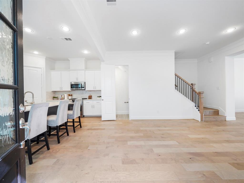 Step into a large and open kitchen, highlighted by the upgraded paint-grade cabinets, stunning quartz countertops, and stainless-steel appliances!