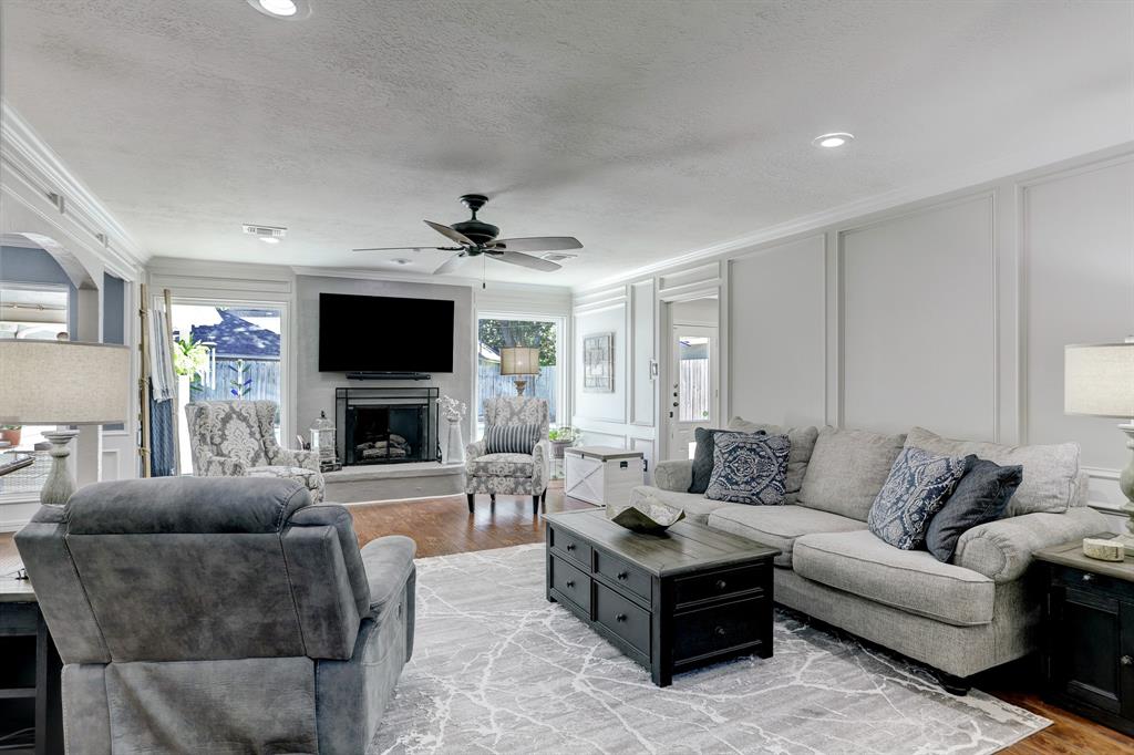 The multiple living areas around the property make it so comfortable. The recessed lighting, handsome wood flooring, and fireplace add to the ambiance.
